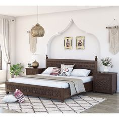 a bedroom with white walls and wooden furniture