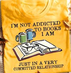 a yellow t - shirt with coffee and books on it