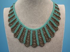 This dainty stylish necklace was hand beaded by one of our group of Mayan women in the village of Santiago Atitlan, Guatemala. It is made with turquoise Czech beads with a touch of bronze accent. The mini hanging loops form a delicate, chic pattern. It looks great with casual wear or with elegant apparel.  Each necklace is individually handmade; therefore there may be a slight variance in the placement and color of the beads. 18"length of top now Toggle enclosure with 3 adjustable loops Bohemian Turquoise Necklaces With Bead Caps, Bohemian Turquoise Necklace With Bead Caps, Mayan Women, Hand Beaded Necklace, Chic Pattern, Stylish Necklace, Necklace Turquoise, Czech Beads, Dainty Necklace