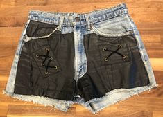 Vintage LEVI STRAUSS & CO 80's shorts with black leather sewn over the jean material.  Excellent condition and look super hot on.  28 Waist Edgy Fitted Leather Shorts, Fitted Edgy Leather Shorts, Edgy Leather Shorts, Black Leather Edgy Shorts, Retro Black Spring Shorts, Edgy Black Leather Shorts, Edgy Leather Shorts For Spring, Edgy Leather Bottoms For Summer, Black Vintage Fitted Shorts