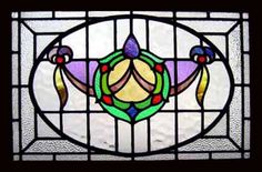 a stained glass window with an ornamental design on it's side panel, in the shape of a flower