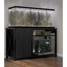 a fish tank sitting on top of a wooden cabinet