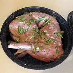 a close up of a cooked chicken in a pan on a table with a spoon