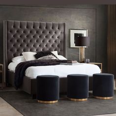 a bed with four stools in front of it