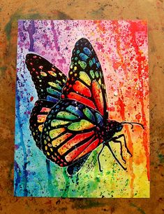 a painting of a colorful butterfly on a piece of paper