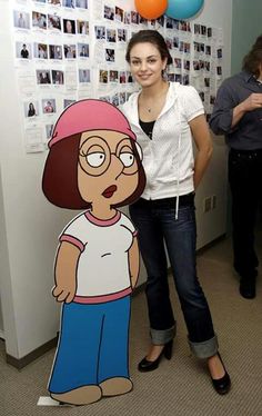 a woman standing next to a cardboard cut out of her character from the cartoon south park