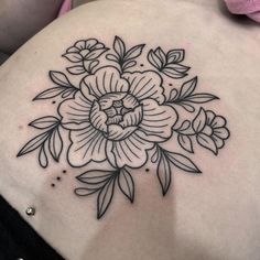 a woman's stomach with a flower tattoo on it