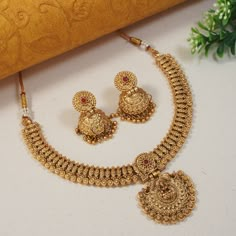 This Beautiful flexible Indian Bollywood necklace jewellery set with earrings is perfect for special occasions such as weddings, formal events, or cultural celebrations. It is certain to add a touch of glamour and sophistication to any outfit, and is guaranteed to make you feel like royalty. If you're looking for a show-stopping piece of jewelry that will make you stand out from the crowd, this set is an excellent choice. Add this charm of Indian Jewelry to your wardrobe and see the heads turn. A perfect enchanting piece of jewelry that is both dramatic and elegant is here to assist you on your special days. Necklace Closure - Adjustable Dori Earrings Closure - Push Back Highest quality and craftsmanship CARE TIP :- 1. Keep away from moisture and perfume. 2. Store in cotton or zip lock bag New Jewellery Designs Gold, Gold Kundan Jewelry Set For Navratri, Traditional Gold Tikka For Marriage, Bridal Necklace Set Gold, Gold Kundan Earrings For Marriage, Gold Jewelry Sets With Zari Work For Wedding, Gold Bollywood Jhumkas For Marriage, Gold Plated Temple Necklace For Diwali Wedding, Bollywood Style Gold Jhumkas For Marriage