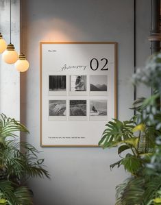 a white poster hanging on the wall next to some potted plants and two lamps