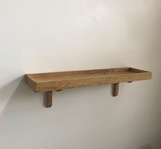 a wooden shelf mounted on the wall