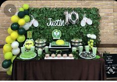 a table with desserts and balloons in front of a backdrop that says justtie