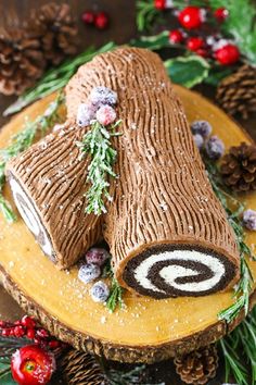 a log cake decorated with icing and pine cones