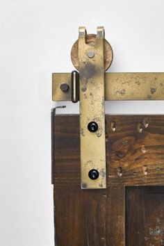 an old wooden door with a metal latch