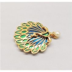 This is part of Chairish’s Costume Jewelry assortment.  1960s goldtone blue and green enameled peacock standing on a faux-pearl brooch with security clasp. Marked "Napier." Measures: 2 1/16 inches long by 1 5/8 inches wide. Condition: Very good; minor wear to the pearl.  Please reference the measurements noted in the description above for the best approximate dimensions. Please reach out to the seller under "Ask the Seller" for specific questions regarding the measurements. Gold Brooches With Peacock Design As Gift, Peacock Brooch, Pearl Brooch, Modern Branding, The Pearl, Vintage 1960s, Blue And Green, Vintage Brooches, Costume Jewelry