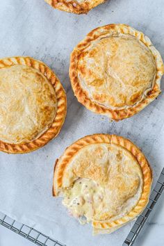 four pies sitting on top of a cooling rack