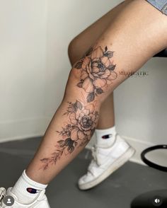 a woman's leg with flowers on it