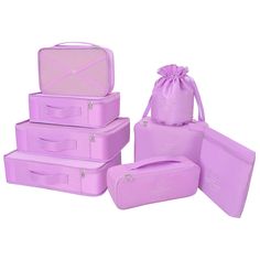 four pieces of pink luggage are stacked on top of each other with a drawstring bag