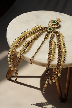 Experience the exquisite allure of our Kundan Mathapatti, a stunning blend of traditional elegance and contemporary charm. This gold-plated headpiece is adorned with vibrant green and gold Kundan stones, delicately complemented by faux pearls, offering a spectacular play of textures. Adjustable and versatile, this piece is perfect for any special occasion, enhancing your style and making an unforgettable statement. Key Features: Intricate Design: Exquisite gold-plated Mathapatti with hand-set vi Elegant Ceremonial Tikka With Tilla Detailing, Ceremonial Festive Tilla Headpieces, Gold Tikka With Stone Work For Festive, Gold Tikka With Stone Work For Festive Occasions, Gold Tikka With Stone Work For Festive Season, Festive Gold Tikka With Stone Work, Elegant Green Tikka For Festive Occasions, Elegant Green Tikka For Festive Season, Gold Tikka With Stone Work For Celebrations