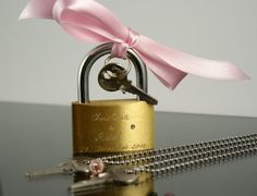 a lock with a pink ribbon tied around it