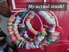 a bunch of different colored ribbons hanging on a red door with the words, my actual stash