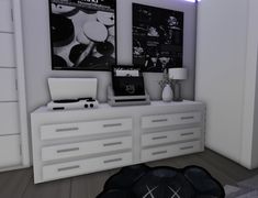 a room with white furniture and posters on the wall above it, along with a black rug