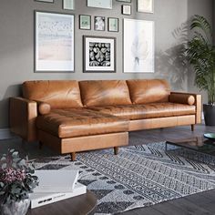 a living room filled with furniture and pictures on the wall