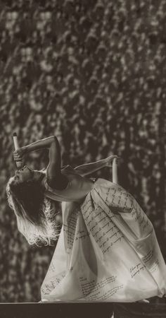 a black and white photo of a woman doing acrobatic