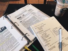 notebooks and pens are sitting on a table