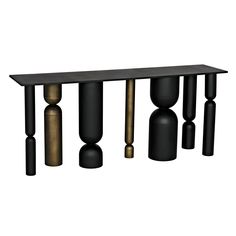 a black and gold console table with three columns on each side, one in the middle