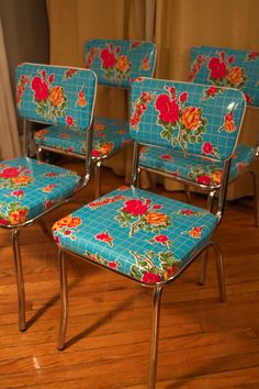 four blue chairs with floral designs on them