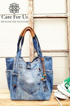 a denim bag sitting on top of a wooden table next to a pair of sneakers