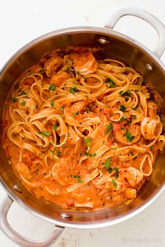 pasta with shrimp and tomato sauce in a pan on a white counter top, ready to be eaten