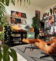 a living room filled with furniture and lots of plants