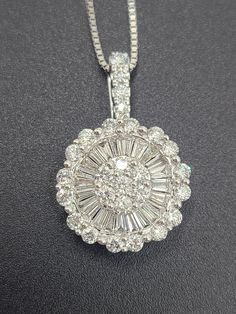 "For Sale: (1) k764 Stunning Ladies 1.25cts Diamond Pendant & 16\" Box Necklace PLEASE READ ENTIRE DESCRIPTION BEFORE PURCHASING This is a gorgeous diamond pendant!! In the center, you have (7) seven round diamonds, followed by a layer of beautifully laid baguette diamonds, then an outer bezel of MORE round diamonds. On the moveable bail, are more round diamonds! This pendant is LOADED!! Sure to put a smile on her face for the holidays! =) Both pendant and chain are stamped 585/14k.  Specifics:  14kt White Gold Diamond Pendant and Chain Length: 16\" Box chain Diamond weight: 1.25cts Pendant length/width: 23mm x 15.19mm Weight: 5.4g/3.4dwt  ----------------------------------------------------------------------------------- Please be 100% sure of your purchase before buying, as we do not off Anniversary Diamond Necklace With Baguette Diamonds, Anniversary Baguette Diamond Necklace, Diamond White Necklace With Baguette Diamonds, Gia Certified Round Diamond Necklace For Wedding, Formal Diamond Pendant Necklace With Baguette Diamonds, Round Baguette Diamond Necklace For Anniversary, Anniversary Round Baguette Diamond Necklace, Gia Certified Round Diamond Necklace, Luxury Round Pendant Diamond Necklace With Diamond Accents