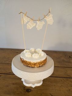 a cake sitting on top of a white plate covered in frosting and bunting