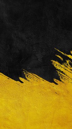 a black and yellow background with some paint strokes on the bottom right side of the image