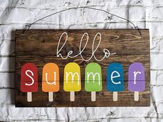 a wooden sign that says hello summer with popsicles on it and the word hello