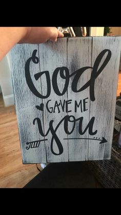 someone holding up a sign that says god gave me you and the words are written on it