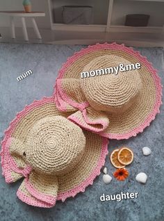 two hats and an orange on the floor with words written below them that read mommy & me