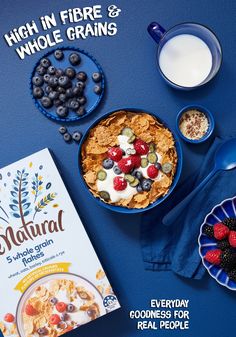 cereal, yogurt and berries are on the table next to a box of oatmeal