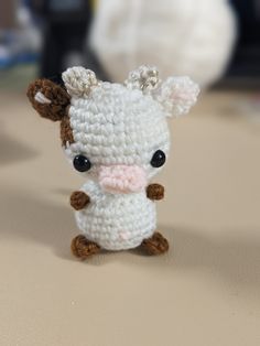 a small crocheted animal sitting on top of a table