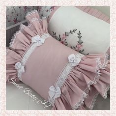 two pillows with ruffles and lace on them