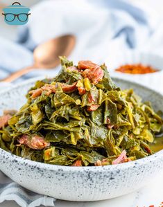 a white bowl filled with collard greens and bacon