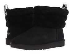 UGG Fluff Mini Quilted (Black) Women's Pull-on Boots Pair the UGG Fluff Mini Quilted with everything from laid-back athleisure looks to gauzy dresses and tights. Supple suede upper with a sheepskin cuff for a cute and cozy wear. Screen-printed glitter graphic for added appeal. Easy pull-on style. Nylon binding. Luxurious sheepskin lining for comfort and warmth. Genuine sheepskin sockliner wicks moisture away and allows air to circulate keeping feet dry. T #UGG #Shoes #Boot #CasualPull-on #Black Womens Ugg, Ugg Booties, Boot Bling, Quilted Boots, Womens Black Booties, Ugg Boots Australia, Black Uggs, Shearling Slippers, Suede Slippers