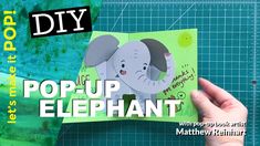 someone is holding up an elephant card with the words pop - up elephant on it