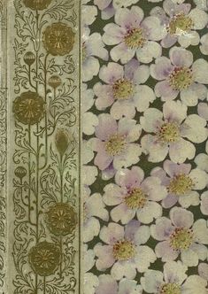 an old book with flowers on it and gold trimming around the edges, in front of a green background