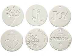 four white ceramic ornaments with the words joy and love