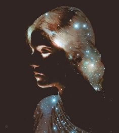 a woman's face with glowing stars in the sky behind her, as if she were looking at something