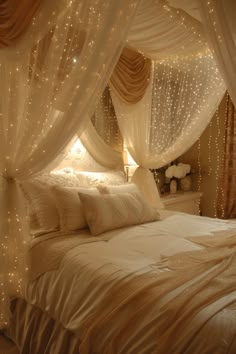 a bed with white sheets and lights on it