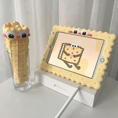 there is an ice cream cone with eyes on it next to a photo frame that says 100